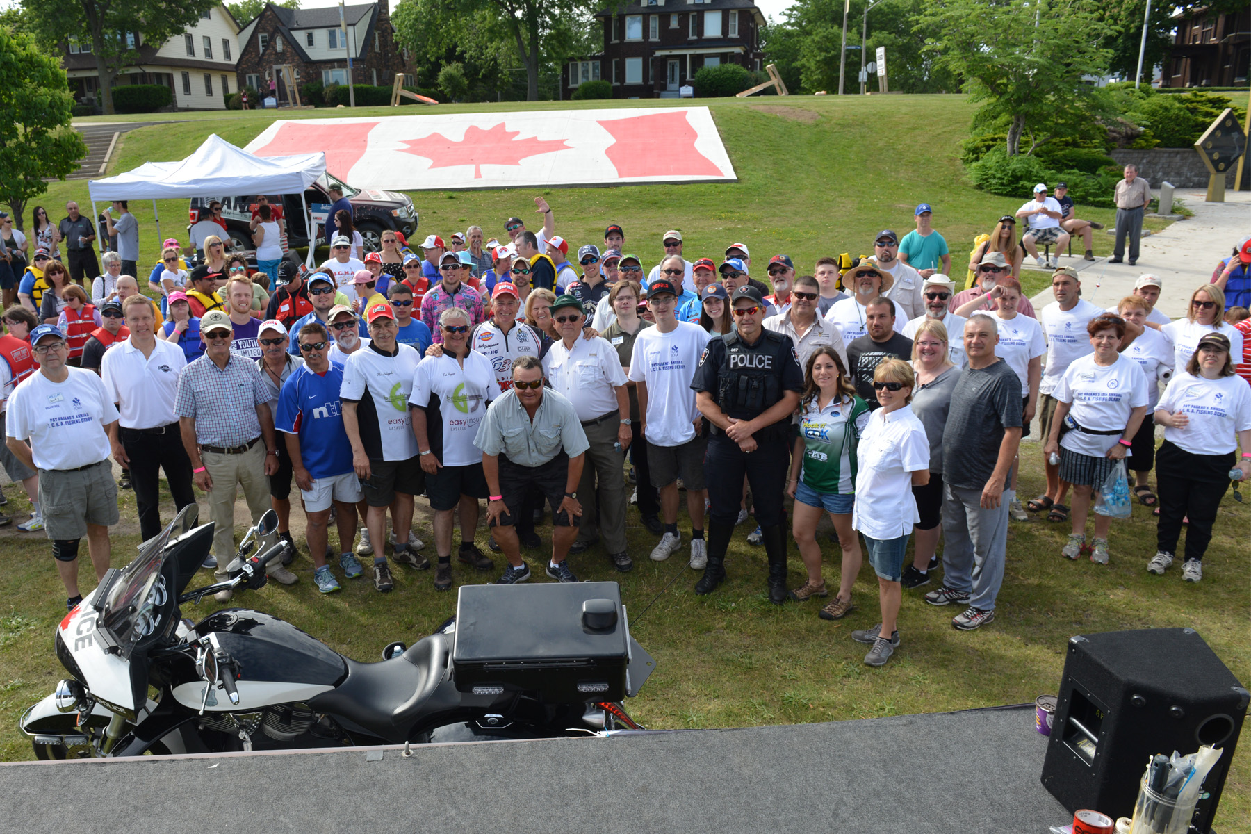 Fishing derby group shot in front of the Canadian Flag