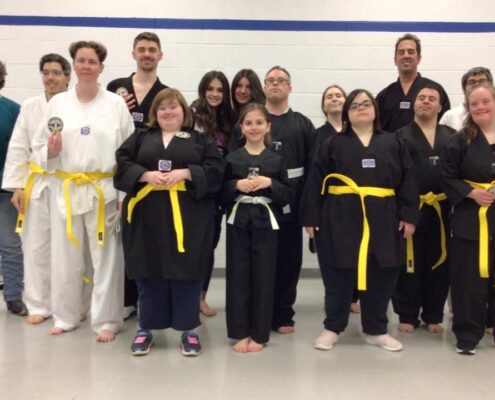 ICHA Taekwondo participants stand with yellow belts