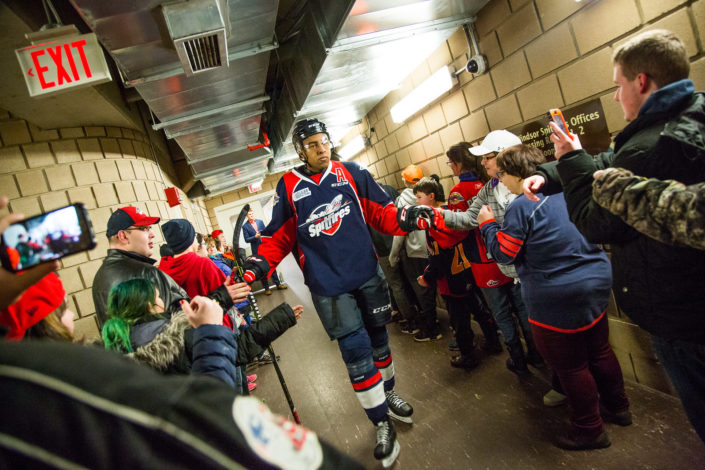 Spitfires player greets ICHA members on his way to the ice.