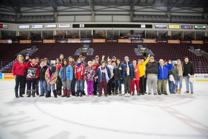 ICHA Spitfires game atendees gather on the ice