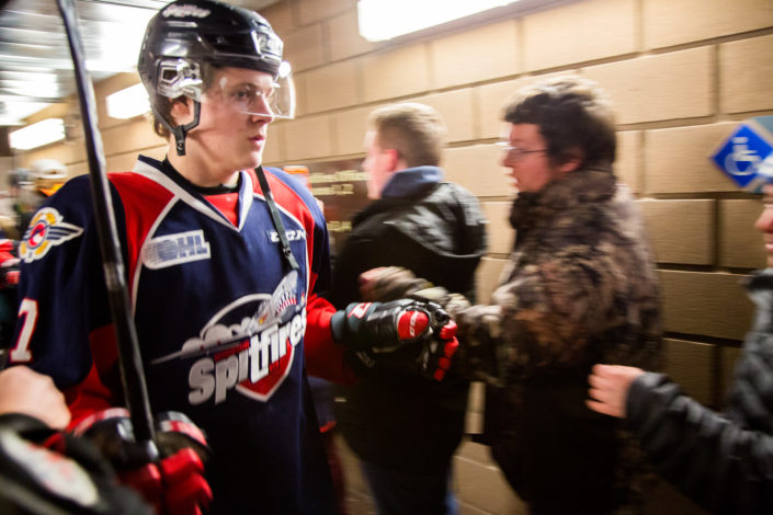 Spitfires player fist bumps ICHA members in passing