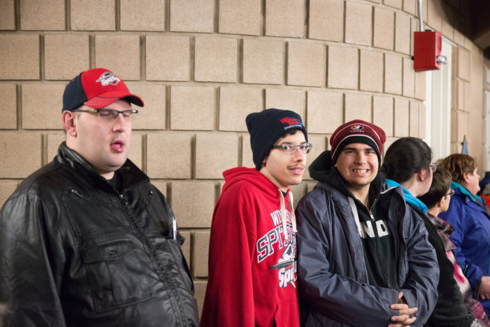 ICHA members wait for Spitfires players to pass by