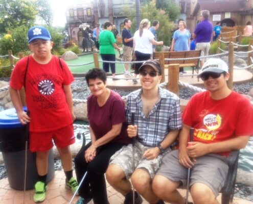 James Benvenuto and Mini Golf Group relax on the bench