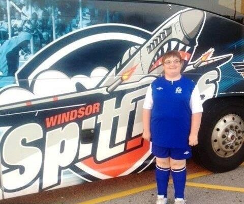 Amy St. Pierre in front of Spitfires charter bus