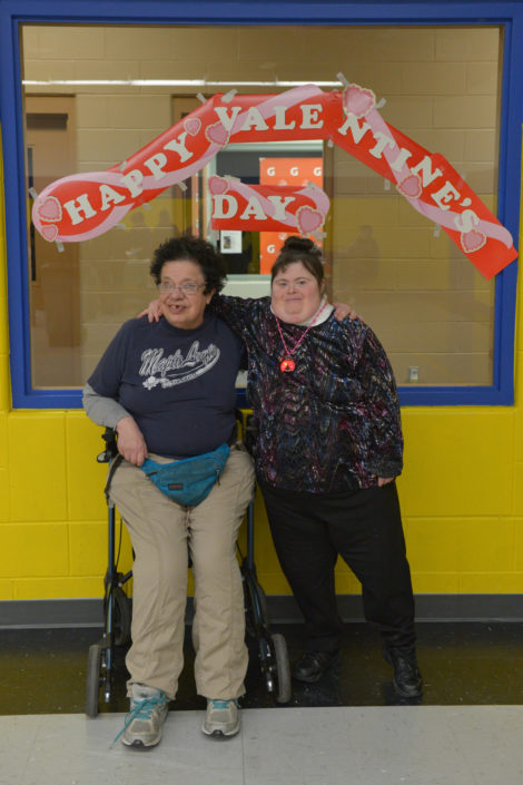Two ICHA members in front of the Valentine's window