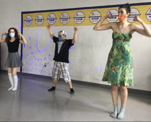 Julia Pastorious, Nic Gatti and Vanessa Gatti do strong arms dance pose