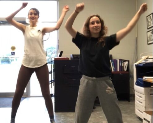 Julia Pastorious and Vanessa Gatti do arm dance pose